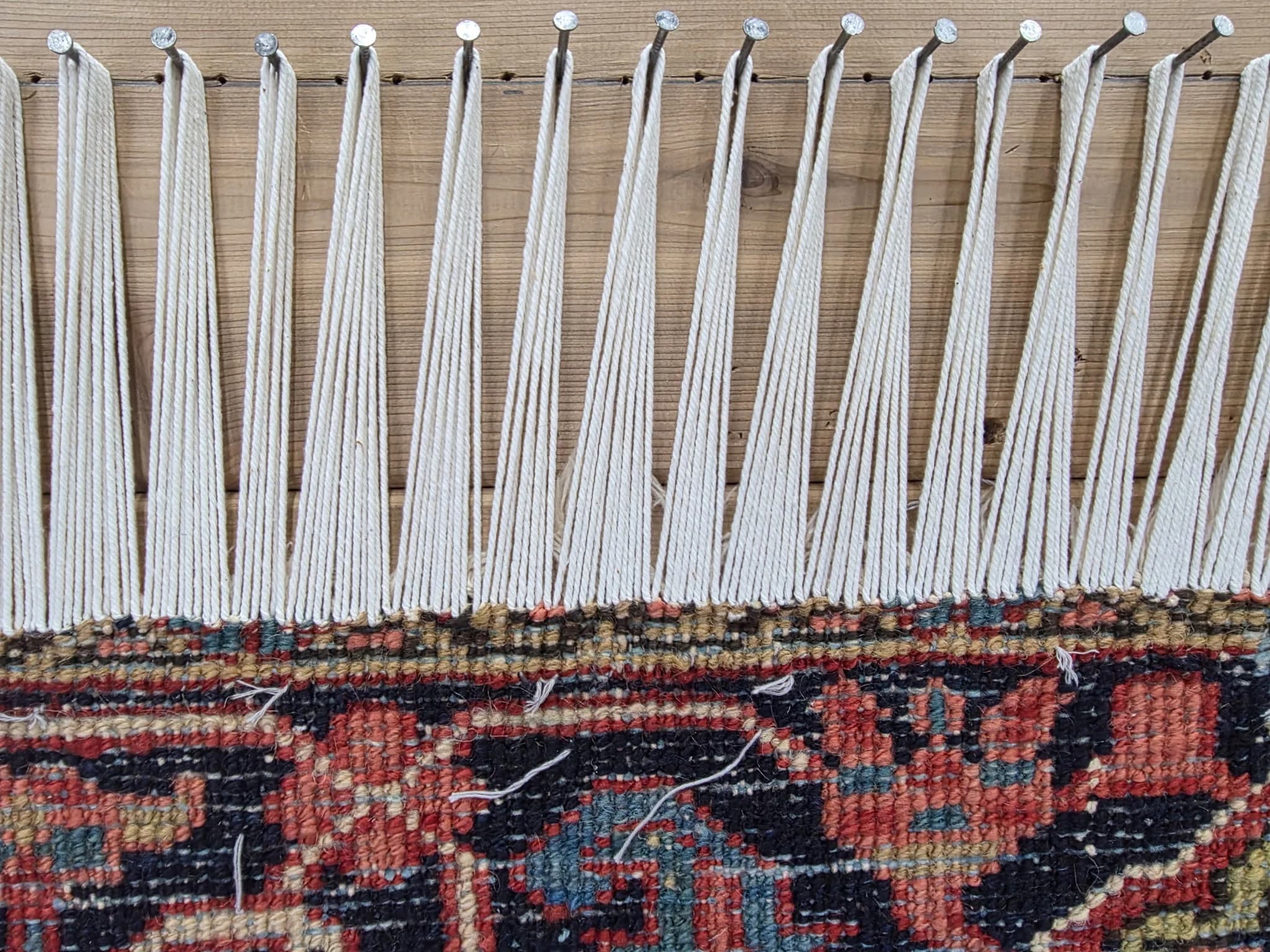 Antique Persian rug with hand-rebuilt warp ends and reconstructed fringe after restoration — Ahmadi Rug, Skokie IL