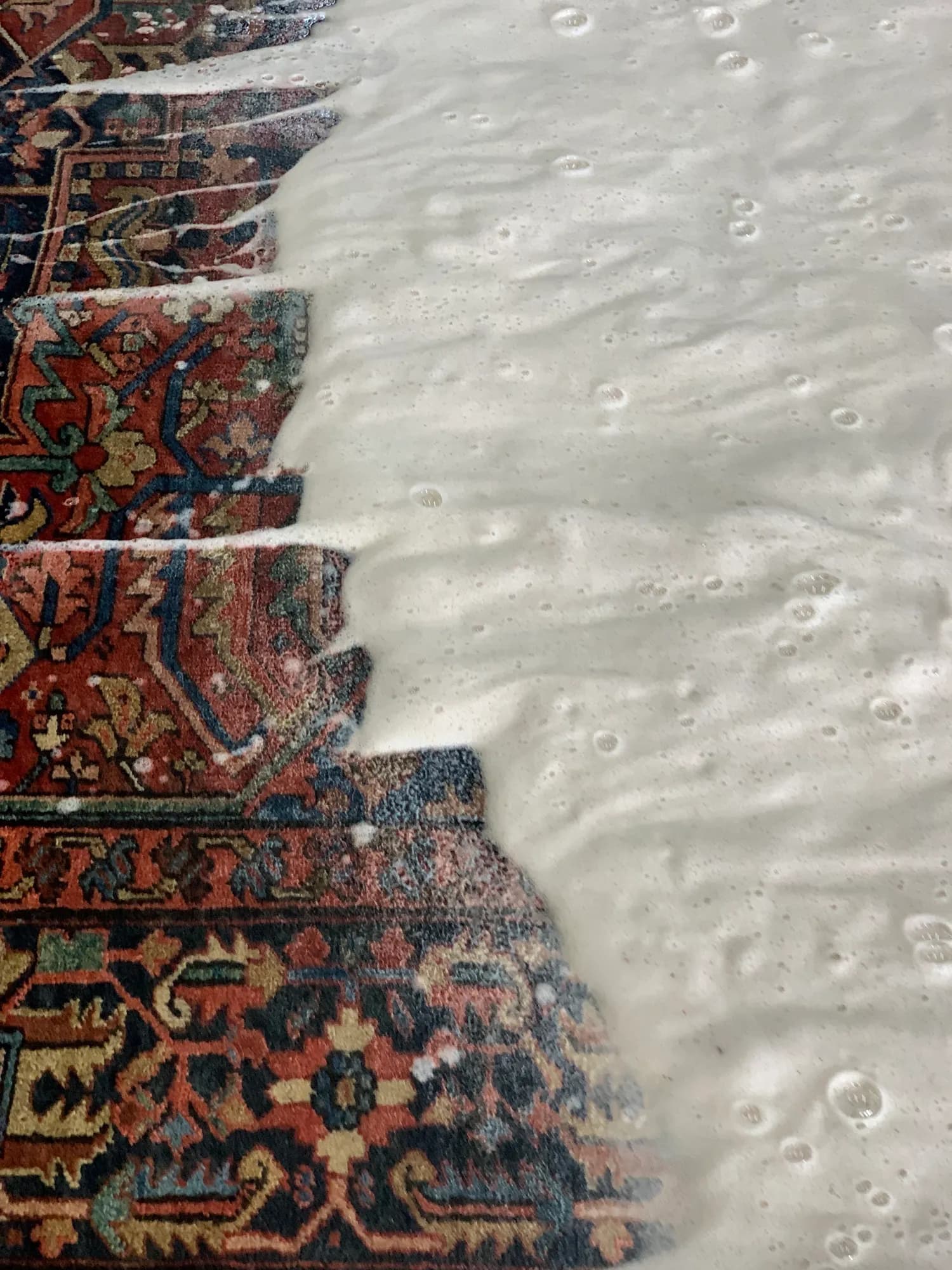 Rug saturated with suds during full-immersion deep wash — Ahmadi Rug workshop, Skokie IL