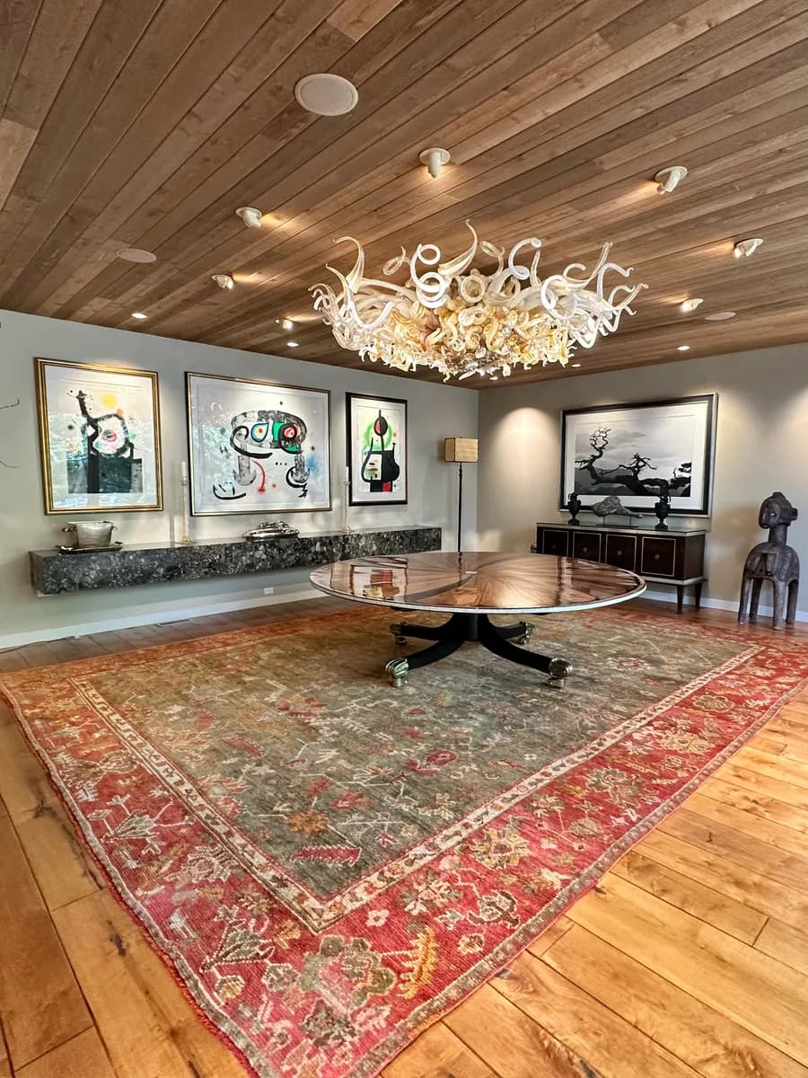 Colour-restored Oushak rug installed in a Wilmette dining room after conservation cleaning — Ahmadi Rug