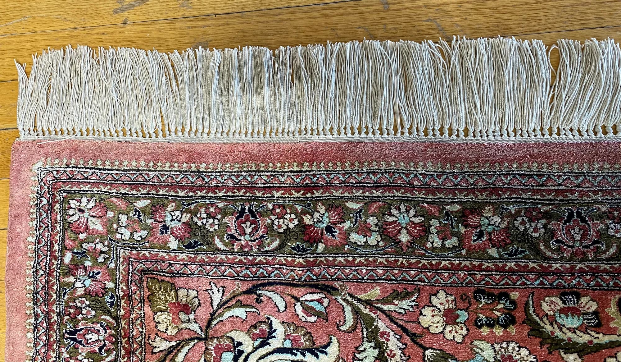 Fine silk floral rug with evenly rewoven fringe after hand restoration — Ahmadi Rug, Skokie IL