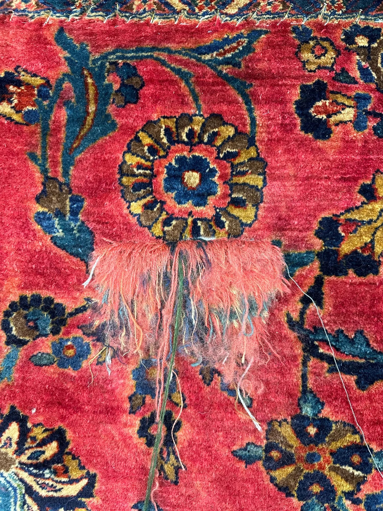 Red Sarouk rug with hand-rewoven pile matching the original design after repair — Ahmadi Rug, Lincoln Park IL