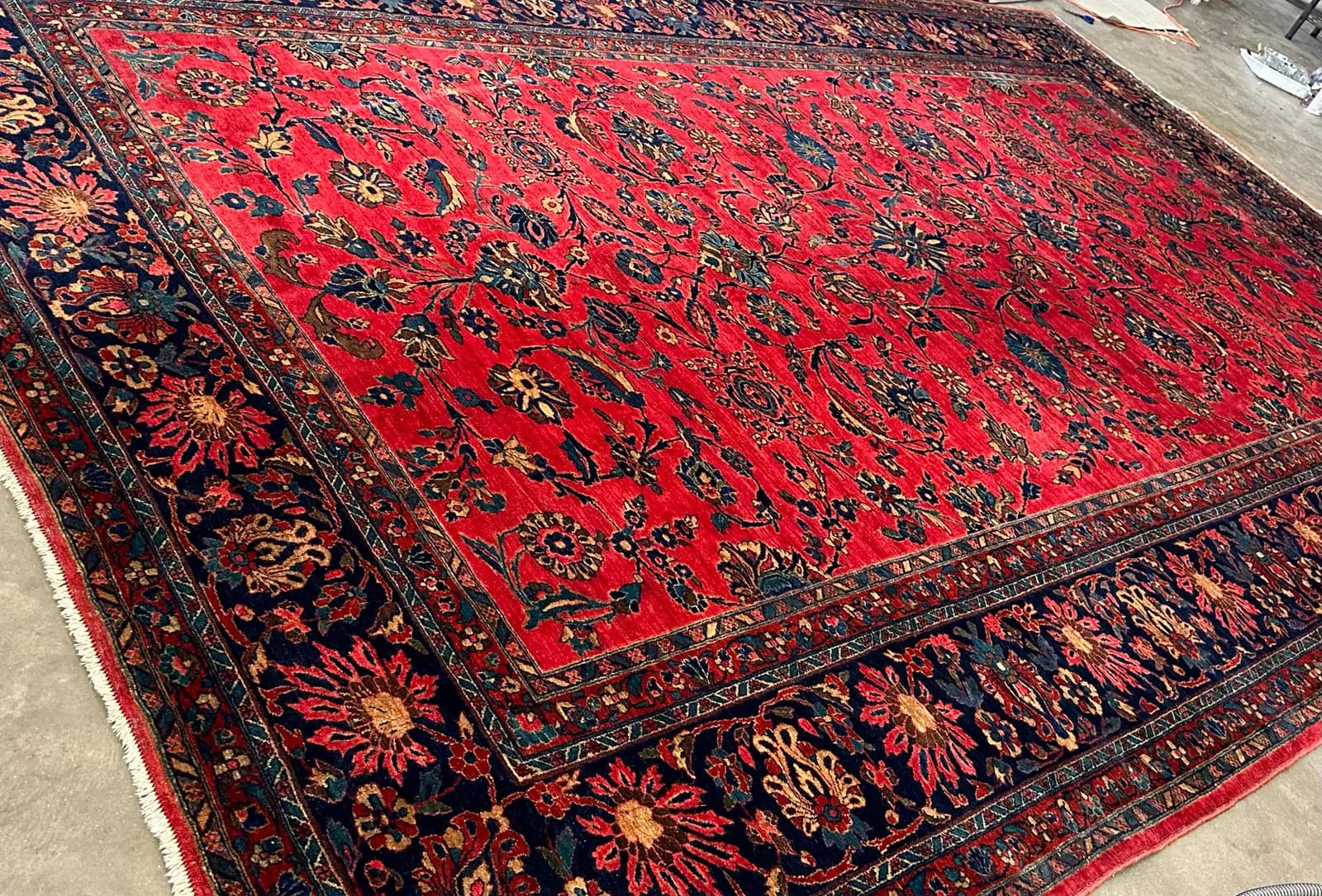 Antique Persian rug laid flat for inspection and measuring before cleaning — Ahmadi Rug, Chicago