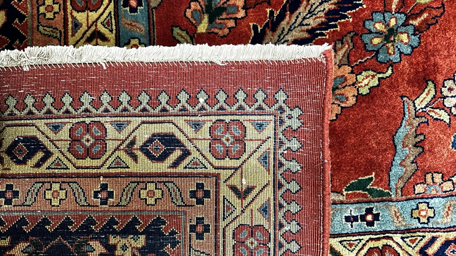 Final inspection of a cleaned Persian rug’s pile and foundation before delivery — Ahmadi Rug, North Shore